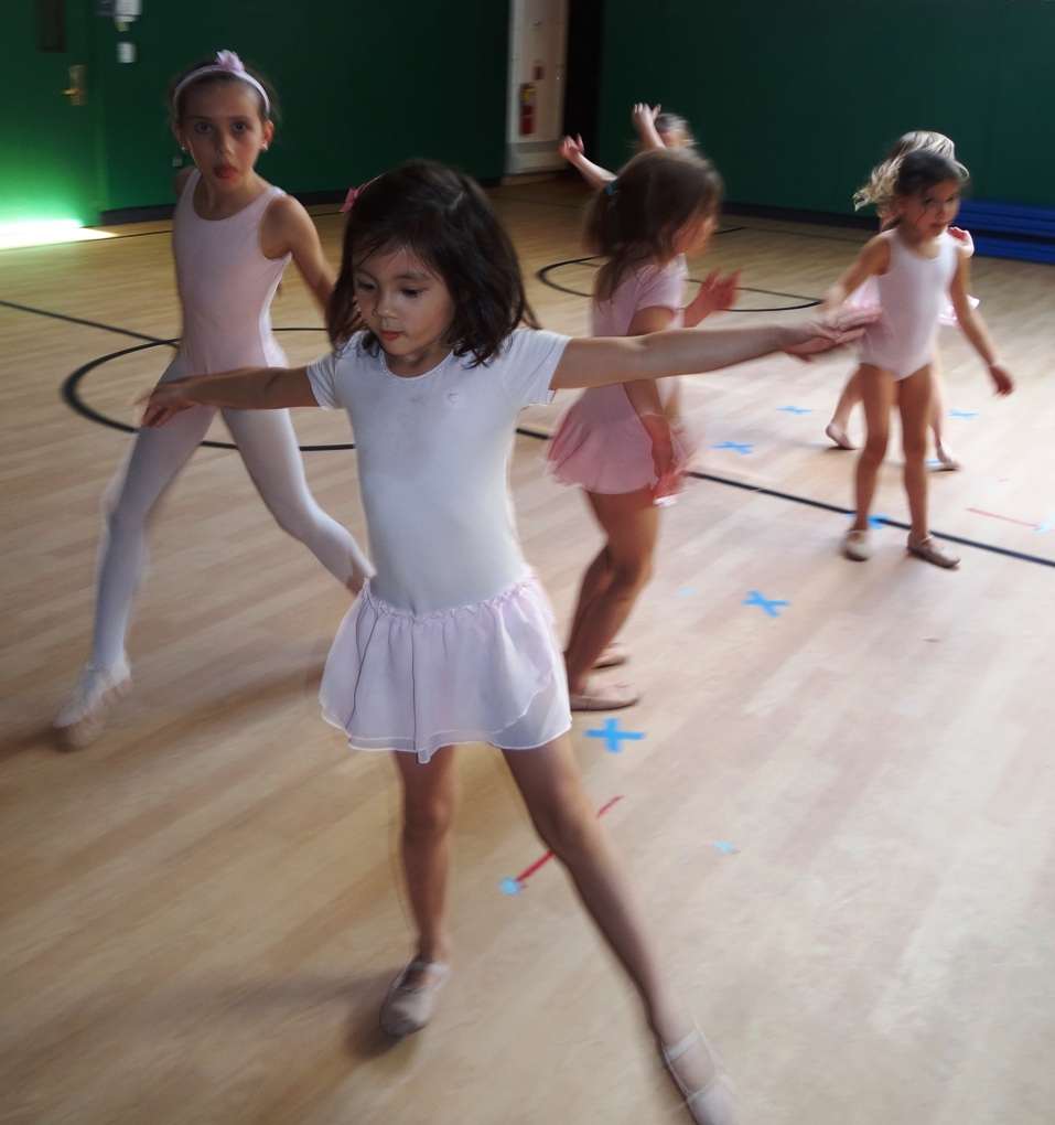 Ballerina poses in Pre-Ballet class